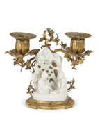Porcelain. A LOUIS XV ORMOLU-MOUNTED CHINESE BLANC-DE-CHINE PORCELAIN TWO-BRANCH CANDELABRUM