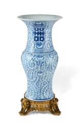 AN ORMOLU MOUNTED CHINESE BLUE AND WHITE 'PHOENIX-TAIL' FORM VASE