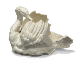 A CONTINENTAL PORCELAIN SAUCE-TUREEN MODELLED AS A SWAN