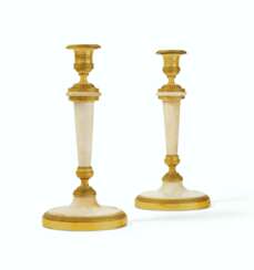 A PAIR OF DIRECTOIRE ORMOLU-MOUNTED WHITE MARBLE CANDLESTICK...