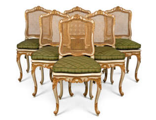 A SET OF SIX LOUIS XV NORTH EUROPEAN WHITE-PAINTED AND PARCEL-GILT, CANED DINING-CHAIRS 