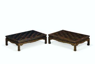A NEAR PAIR OF CHINESE BLACK AND GILT-LACQUER KANG LOW TABLES