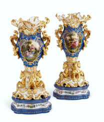 A PAIR OF JACOB PETIT PORCELAIN BLUE AND GOLD GROUND RETICULATED VASES ON STANDS