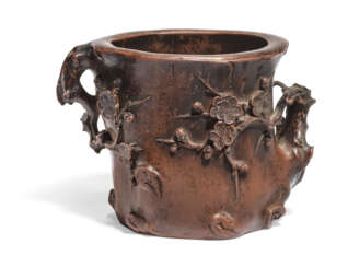 A FINELY MODELLED YIXING STONEWARE 'PLUM BLOSSOM' BRUSHPOT