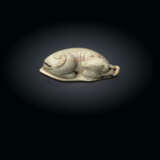 A RARE 'CHICKEN-BONE' JADE CARVING OF A DOG - photo 1