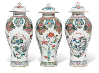 A LARGE SET OF THREE FAMILLE ROSE BALUSTER VASES AND COVERS ...