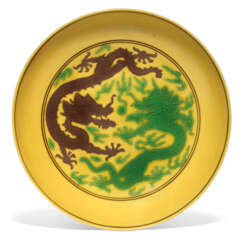 A YELLOW-GROUND GREEN AND AUBERGINE-ENAMELLED 'DRAGON' DISH ...