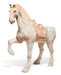 A PAINTED RED POTTERY FIGURE OF A PRANCING HORSE