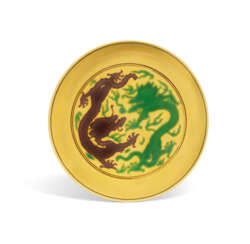 A YELLOW-GROUND GREEN AND AUBERGINE-ENAMELLED 'DRAGON' DISH ...