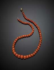 Graduated orange coral bead necklace with bi-coloured gold clasp