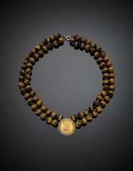 Two strand tiger's eye bead necklace with a yellow gold 1963 pound central