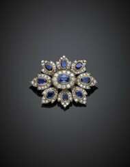 Round diamond and oval sapphire silver and gold stylized flower brooch