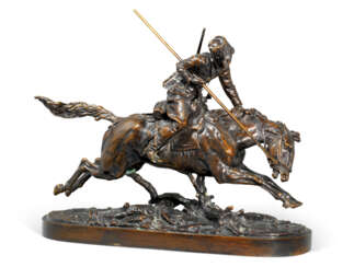 A BRONZE MODEL OF A CHARGING COSSACK