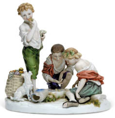 A LARGE AND RARE PORCELAIN FIGURE OF THREE CHILDREN PLAYING ...