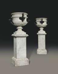 A PAIR OF ITALIAN PATINATED-BRONZE MOUNTED WHITE MARBLE VASES ON PEDESTALS