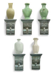 A GROUP OF FIVE CHINESE MONOCHROME VASES ON SIMULATED-VERDIGRIS BRACKETS