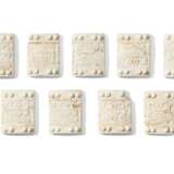 NINE CARVED WHITE STONE PLAQUES - photo 1