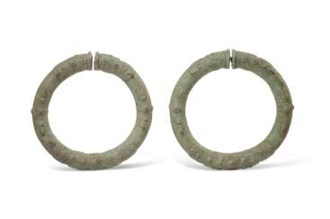 A PAIR OF LARGE BRONZE BANGLES OR ARMLETS