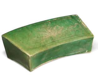 A GREEN AND AMBER-GLAZED PILLOW