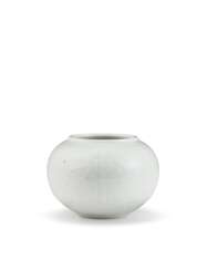 A SMALL CARVED WHITE-GLAZED OVOID JAR