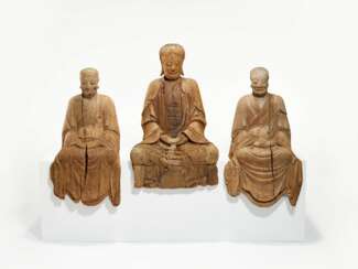 A GROUP OF THREE LARGE CARVED WOOD BUDDHIST FIGURES