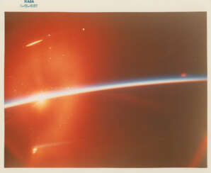First human-taken photograph from space; orbital sunset, February 20, 1962