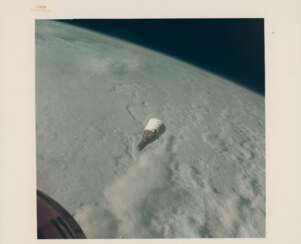 Gemini VII above the cloud-covered Earth; the spacecraft maneuvering over the Earth at dawn, December 15-16, 1965