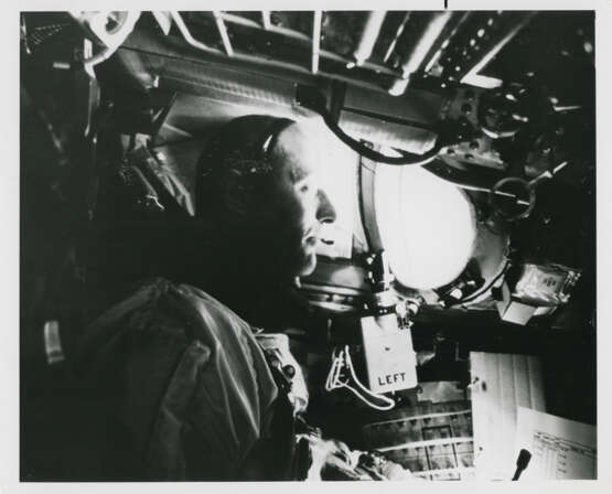 Thomas Stafford in weightlessness looking through the window; EVA photograph: umbilical cord between the spacewalker and the spacecraft, June 3-6, 1966 - photo 1