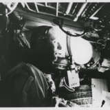 Thomas Stafford in weightlessness looking through the window; EVA photograph: umbilical cord between the spacewalker and the spacecraft, June 3-6, 1966 - фото 1
