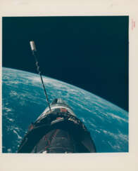 EVA photograph: Gemini XII docked with Agena over the Pacific Ocean; Buzz Aldrin’s stand-up EVA in the open hatch of the spacecraft, November 11-15, 1966