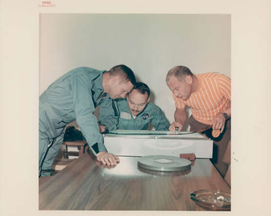 The crew examining the photographic film; NASA officials receiving treasures; scientists studying lunar rocks; ticket parade, July-September 1969 - фото 1