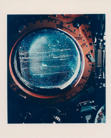 Telephotograph of the Crescent Earth; streaked window of the CM; edge of the docked LM, during translunar coast, November 14-24, 1969 - photo 3