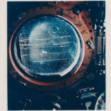 Telephotograph of the Crescent Earth; streaked window of the CM; edge of the docked LM, during translunar coast, November 14-24, 1969 - photo 3