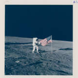 Pete Conrad holding the US flag on the Ocean of Storms; close-up of the Solar Wind Collector, November 14-24, 1969, EVA 1 - photo 1