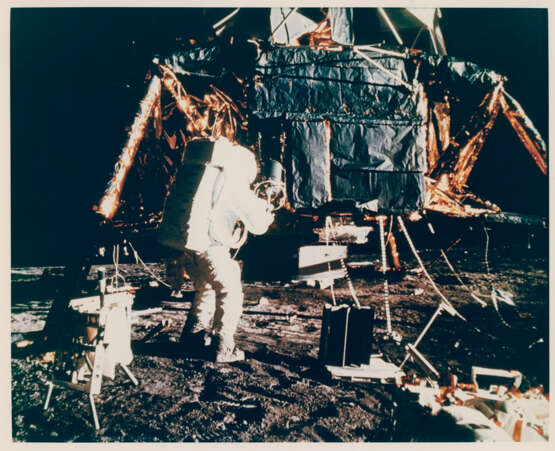 Views of Alan Bean preparing to carry the scientific equipment; Bean and the LM; Bean trying to remove a radioactive fuel element, November 14-24, 1969, EVA 1 - photo 3