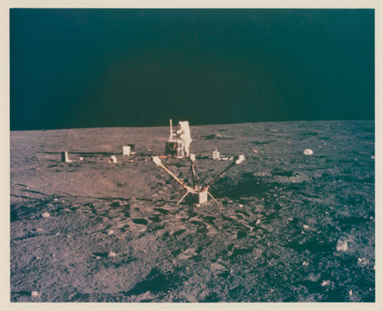 Views of Pete Conrad at the lunar-science station, the Passive Seismic Experiment; Alan Bean with the LM in the background, November 14-24, 1969, EVA 1 - photo 7