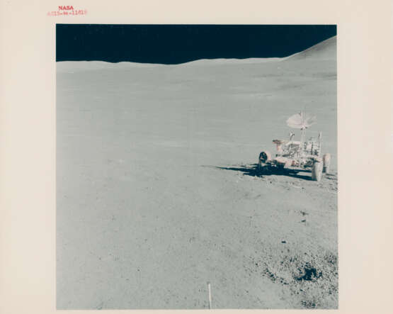 The Lunar Rover with the landing site in the far background; David Scott adjusting the TV antenna towards Earth, station 6, July 26-August 7, 1971, EVA 2 - фото 1