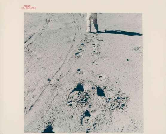 James Irwin climbing toward the Rover; human footprint; astronauts’ shadows; David Scott preparing to take a photograph, station 6, July 26-August 7, 1971, EVA 2 - фото 1
