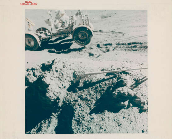 James Irwin holding the Lunar Rover from sliding downhill; the Green Boulder in the valley of Hadley-Apennine, station 6A, July 26-August 7, 1971, EVA 2 - photo 1