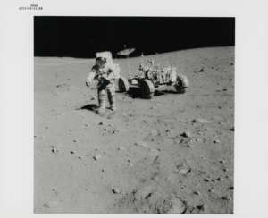 David Scott with the 500mm Hasselblad camera; Hadley Canyon and Mount Hadley Delta; astronaut shadow and lunar rock, station 10, July 26-August 7, 1971, EVA 3