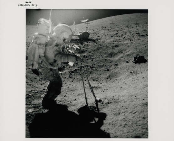 John Young collecting lunar soil; Young at the back of the Rover; boulder, scoop and tongs, station 6; TV picture at station 5, April 16-27, 1972, EVA 2 - photo 1