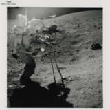John Young collecting lunar soil; Young at the back of the Rover; boulder, scoop and tongs, station 6; TV picture at station 5, April 16-27, 1972, EVA 2 - photo 1