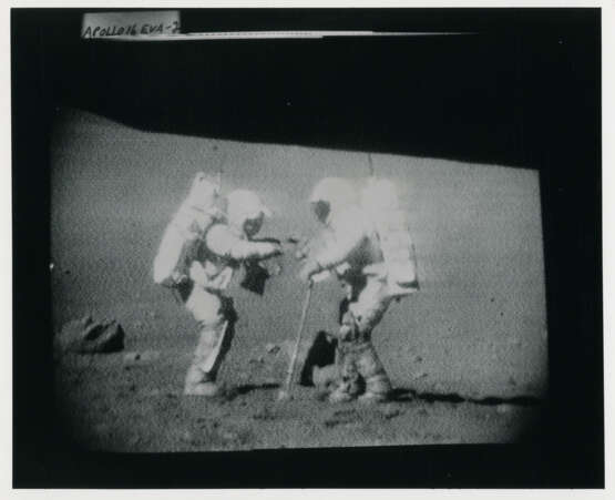 John Young pointing the Rover antenna toward Earth; TV pictures at Wreck Crater; Charles Duke hammering a double core tube, station 8, April 16-27, 1972, EVA 2 - photo 10
