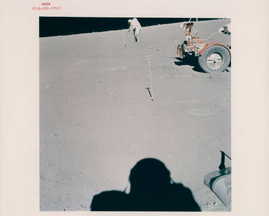 John Young pointing the Rover antenna toward Earth; TV pictures at Wreck Crater; Charles Duke hammering a double core tube, station 8, April 16-27, 1972, EVA 2 - photo 12