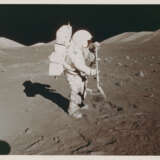 Harrison Schmitt holding the rake; TV pictures; the rim of Steno Crater; footprints; the rising Sun illuminating the Rover, station 1, December 7-19, 1972, EVA 1 - фото 1