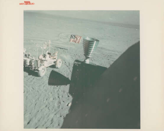 Portrait of Harrison Schmitt with the reflection of the photographer in his visor; the Rover and the US flag from the LM window, December 7-19, 1972, EVA 3 and post EVA 2 - фото 3