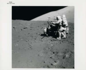 Eugene Cernan next to the Rover; sunstruck photograph of Harrison Schmitt jumping into the LMP seat of the Rover, station 9, December 7-19, 1972, EVA 3