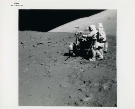 Eugene Cernan next to the Rover; sunstruck photograph of Harrison Schmitt jumping into the LMP seat of the Rover, station 9, December 7-19, 1972, EVA 3 - Foto 1
