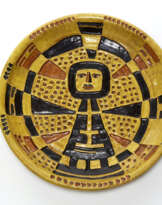 Decorative enameled plate in shades of ocher yellow and brown