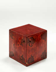 Pouf in wood covered in spotted red lacquer
